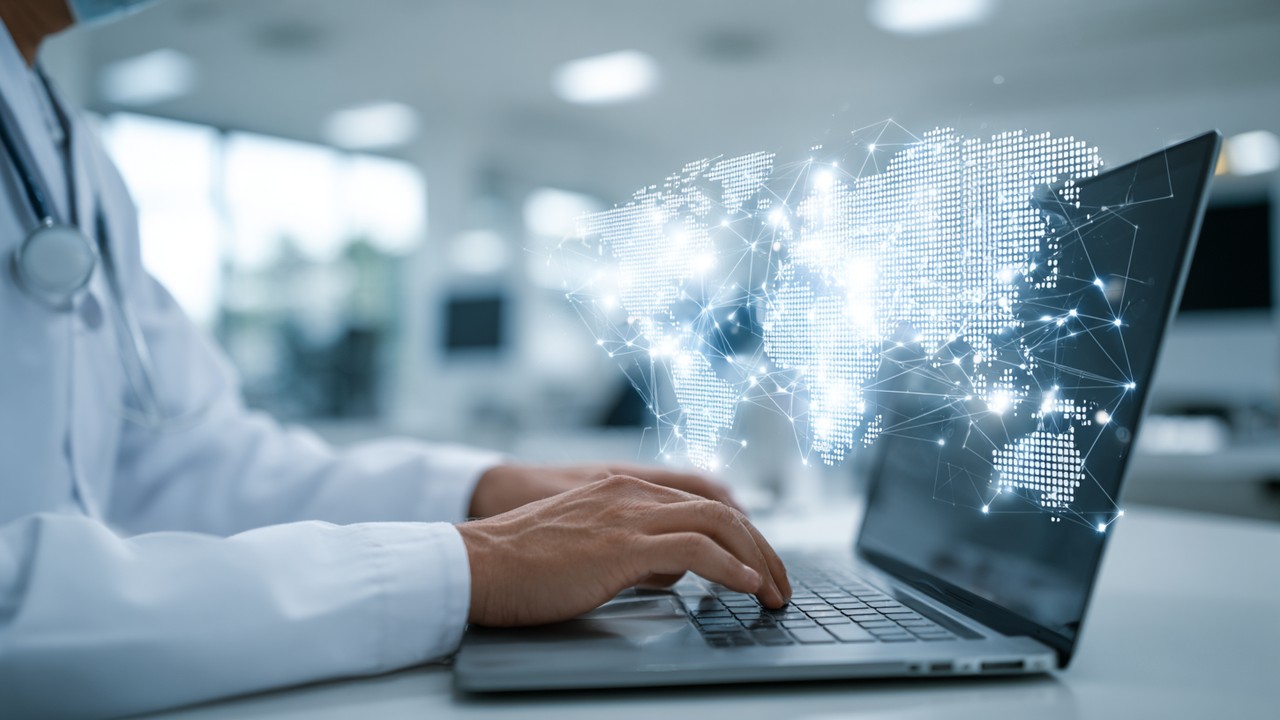 Healthcare IT specialist configuring a Content Delivery Network on a laptop with global network node displays in a modern workspace, emphasizing digital optimization.