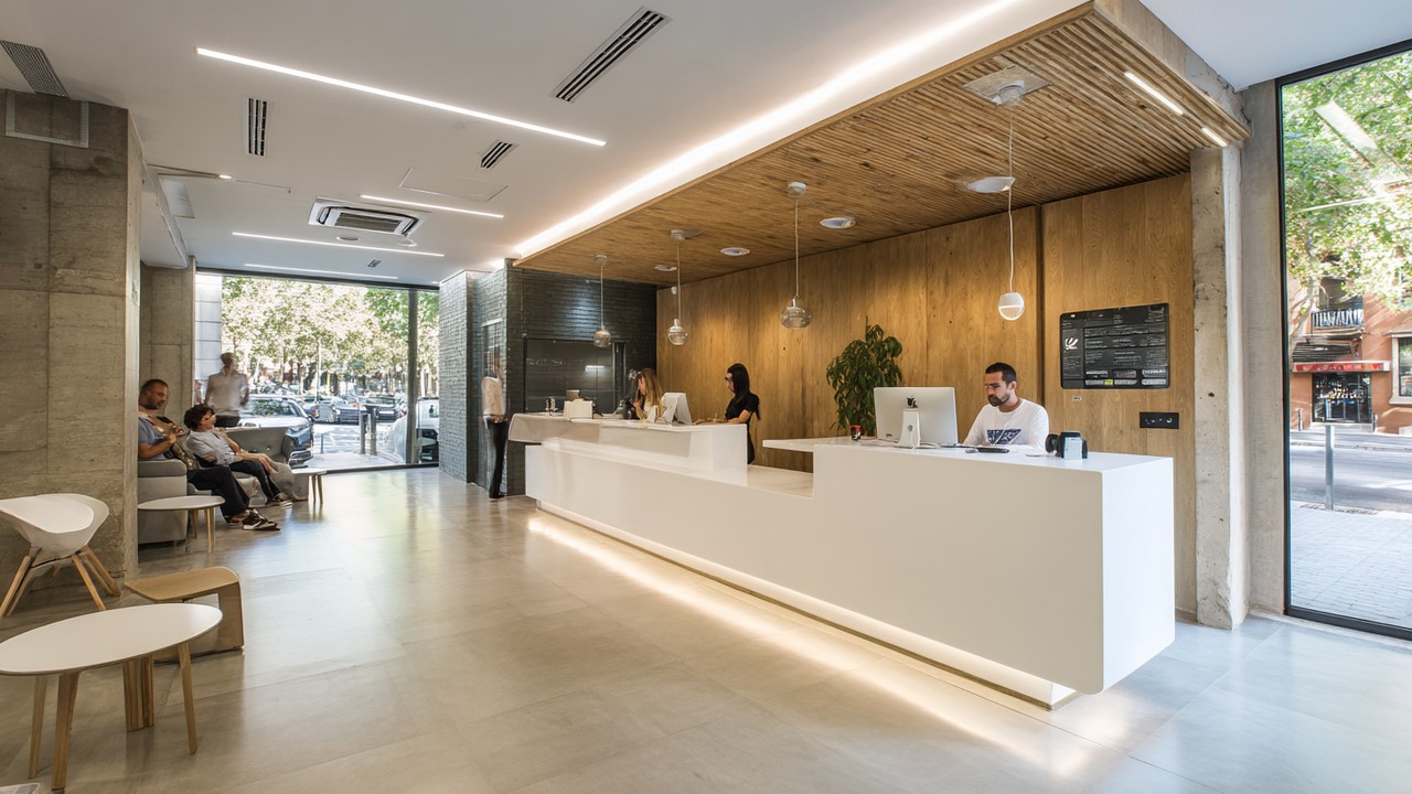 Modern cosmetic care clinic reception in Barcelona with sleek design, friendly staff, natural lighting, and a welcoming, professional atmosphere.