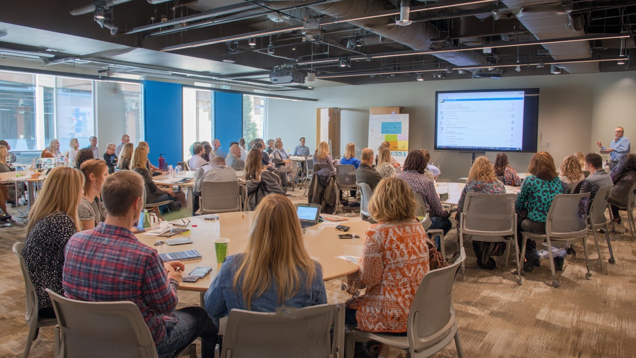 Diverse healthcare professionals attending a training seminar on patient safety and risk management in a modern conference room.