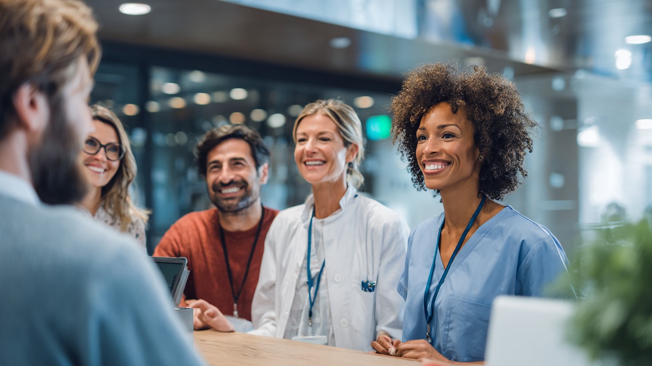 Diverse international patients consulting with healthcare professional in modern clinic, showcasing trust and accessibility in medical tourism.
