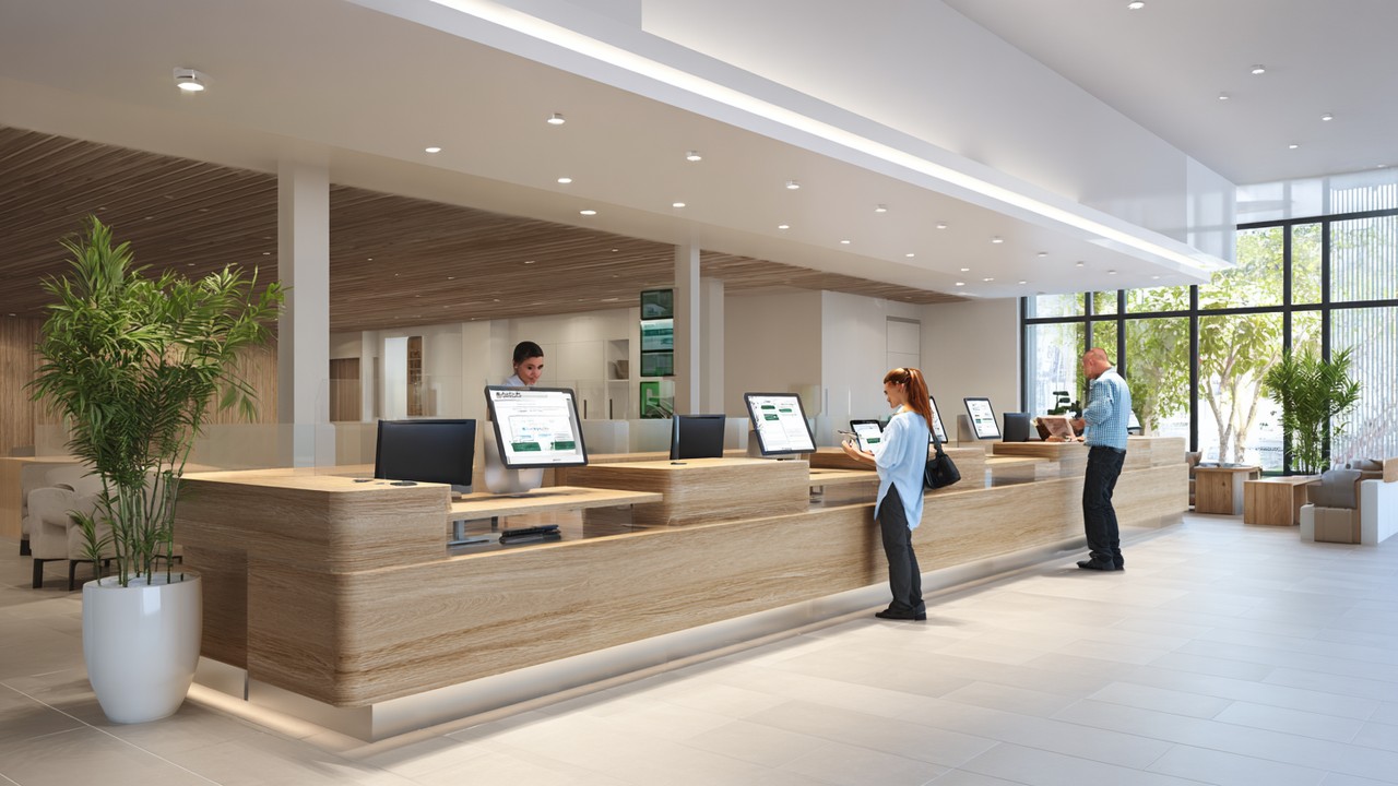 Modern health tourism clinic reception with international patients using digital devices, reflecting trust and efficient healthcare services.