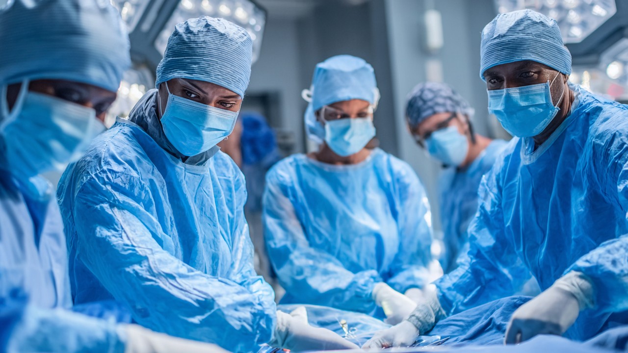 Rapid response medical team performing emergency orthopedic surgical drill in a surgical suite, demonstrating preparedness and coordination.